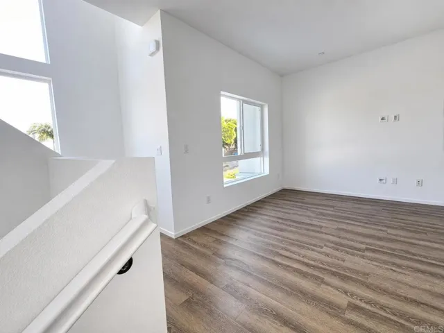 Open-concept living space with abundant natural light and durable flooring.