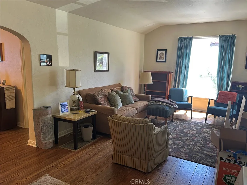 Living room, arched doorways, coved ceilings, large front window