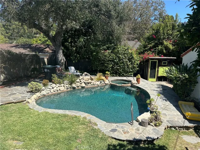 Pool with spa and rock waterfall feature