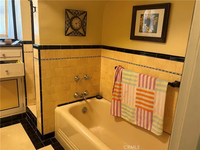 Bathroom with tub and shower, with that 1930's tile