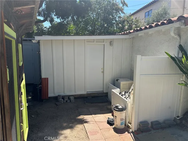 Shed or workshop attached to garage, chicken coop on the left, pool filter equipment on the right