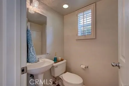 Pretty powder room with a window and pedestal sink