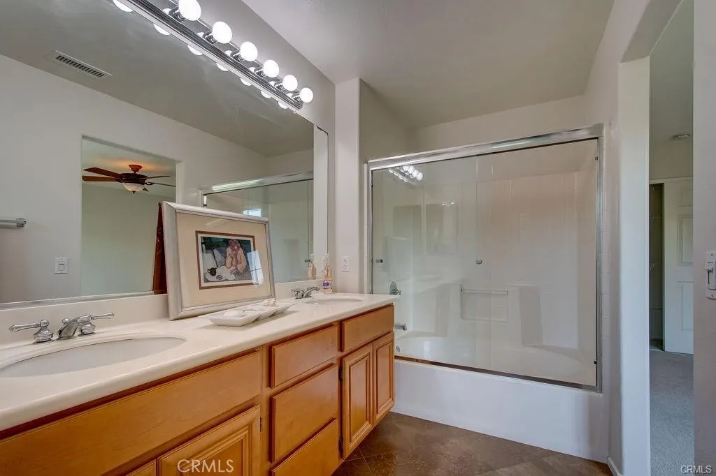 Shower over the tub and dual sinks in the Primary Bath