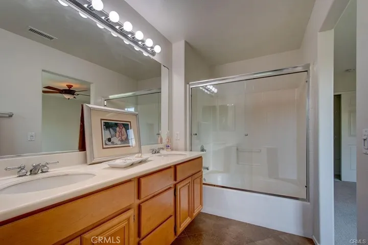 Shower over the tub and dual sinks in the Primary Bath