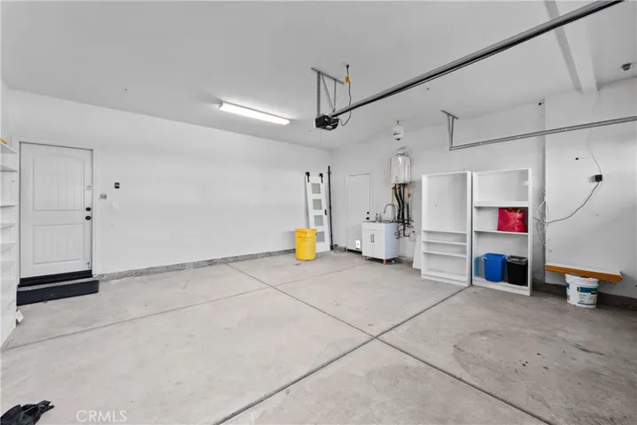 Attached Two Car Garage With Direct Access and Shelving