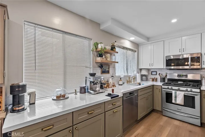 Kitchen with stainless steel appliances and quartz countertops