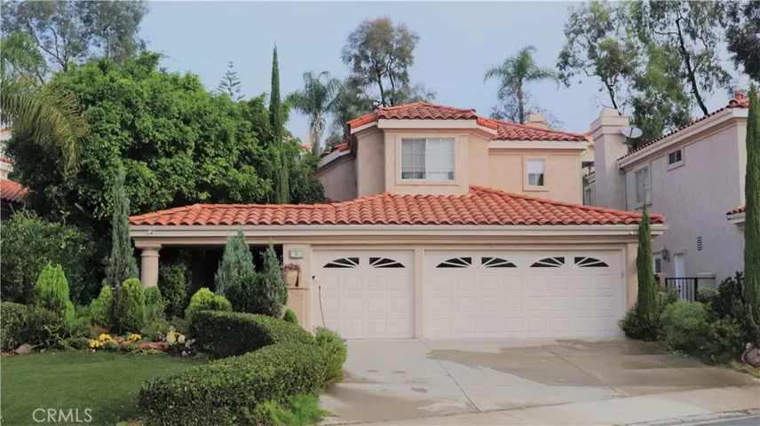 Exterior view with three car garage and private gated entrance.