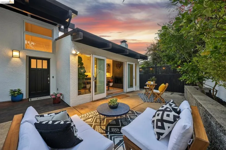 Expansive concrete patio with direct access to interior spaces through glass French doors
