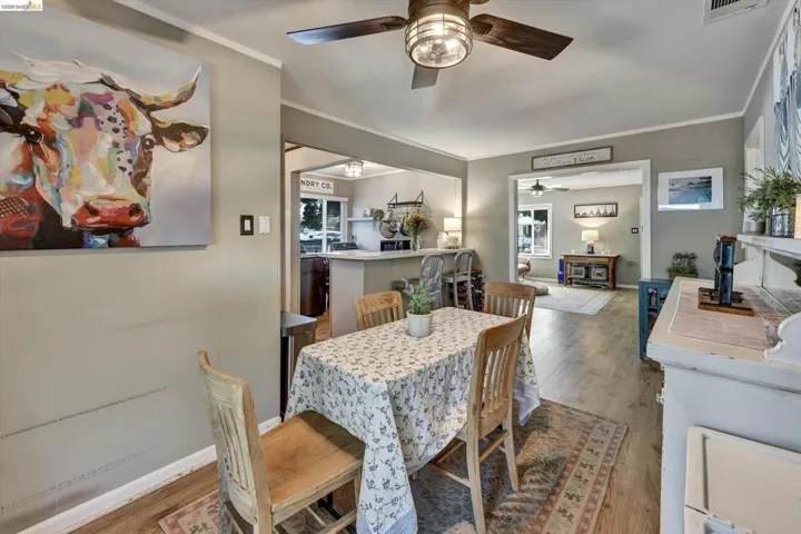 Dining area featuring wood-finish flooring and a ceiling fan with integrated lighting