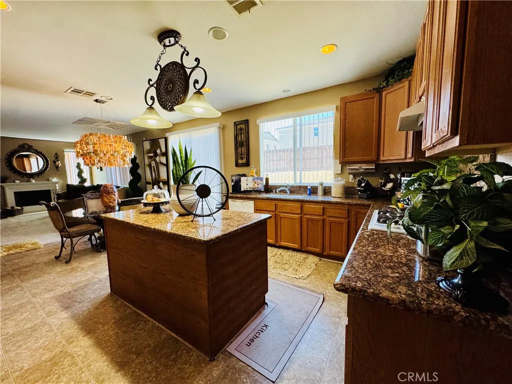 Entering Well Designed Kitchen From the Formal Dining Room Featuring Convenient Kitchen Island.