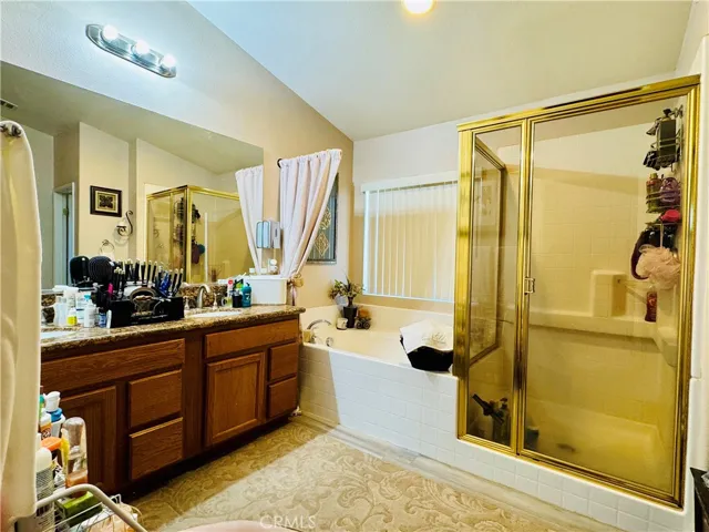 Primay Ensuite Bathroom Grooming Area, Soaking Tub and Enclosed Walk-in Shower