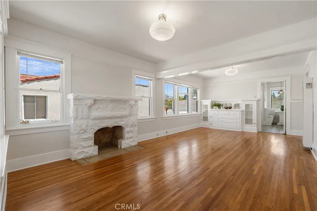 Living Room with beautiful ornate fireplace and built-in cabinetry