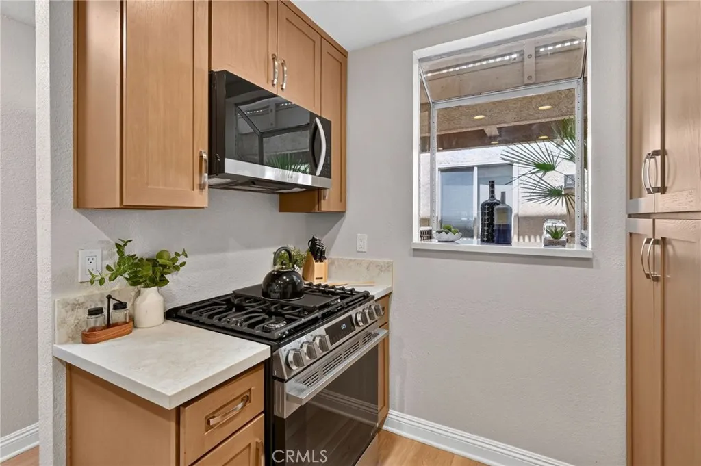 The kitchen has new wood cabinets, quartz countertops, and Stainless Steel LG appliances