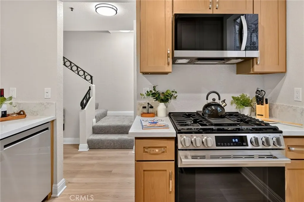 The kitchen has new wood cabinets, quartz countertops, and Stainless Steel LG appliances