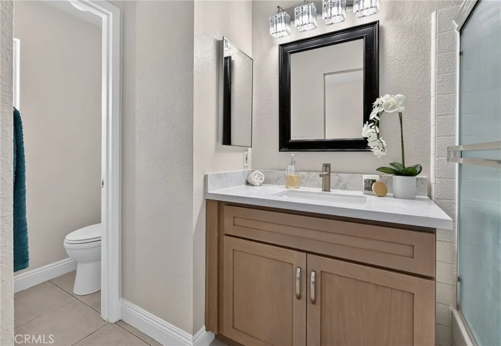 Primary Bathroom has a brand new vanity, lighting, and faucet fixtures