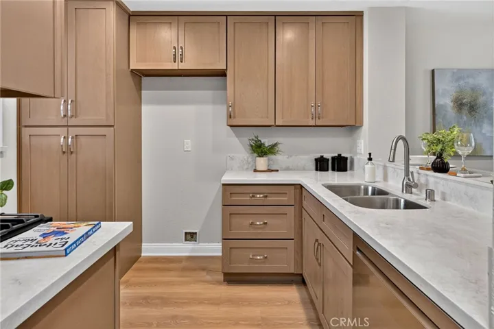 The kitchen has new wood cabinets, quartz countertops, and Stainless Steel LG appliances