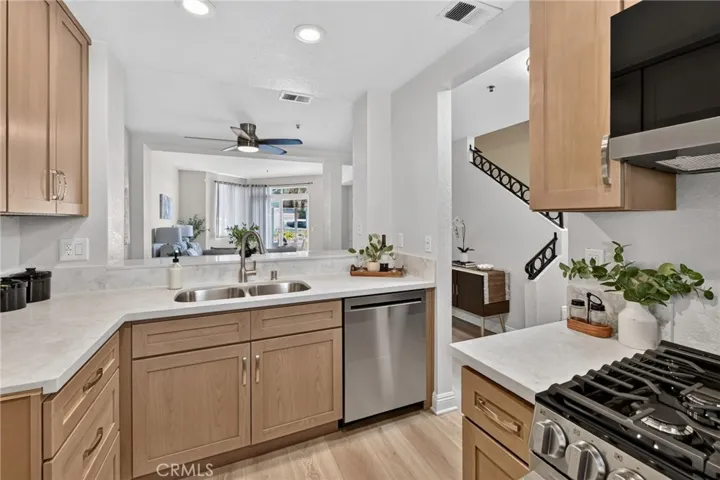 The kitchen has new wood cabinets, quartz countertops, and Stainless Steel LG appliances