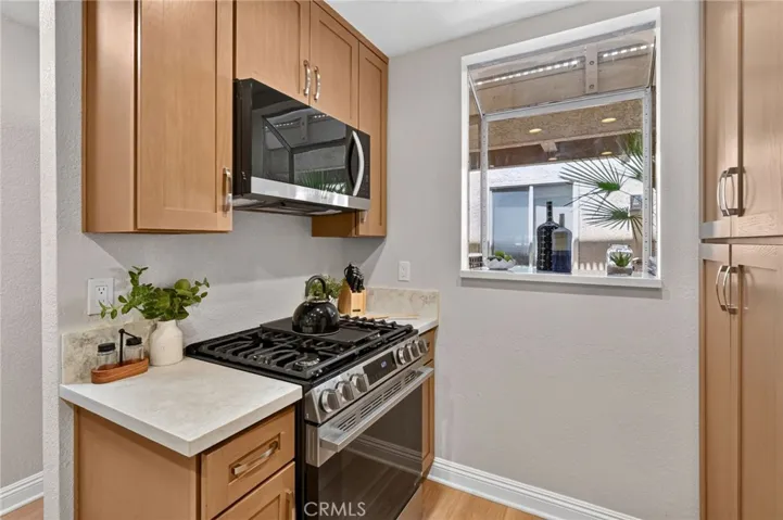 The kitchen has new wood cabinets, quartz countertops, and Stainless Steel LG appliances