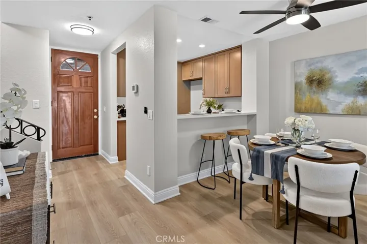 The front door opens into the kitchen and leads to the dining room and living room.   New paint, flooring and light fixtures!