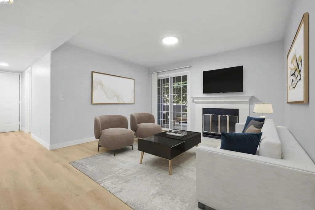 Bright and sophisticated living room showcasing light wood-finish flooring, soft gray walls, and recessed ceiling lighting