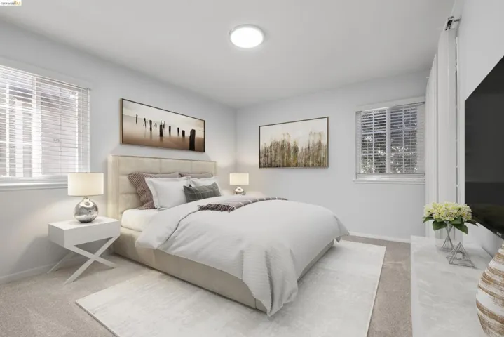 Serene primary bedroom featuring a neutral upholstered bed frame, dual nightstands with integrated lighting, and soft layered bedding