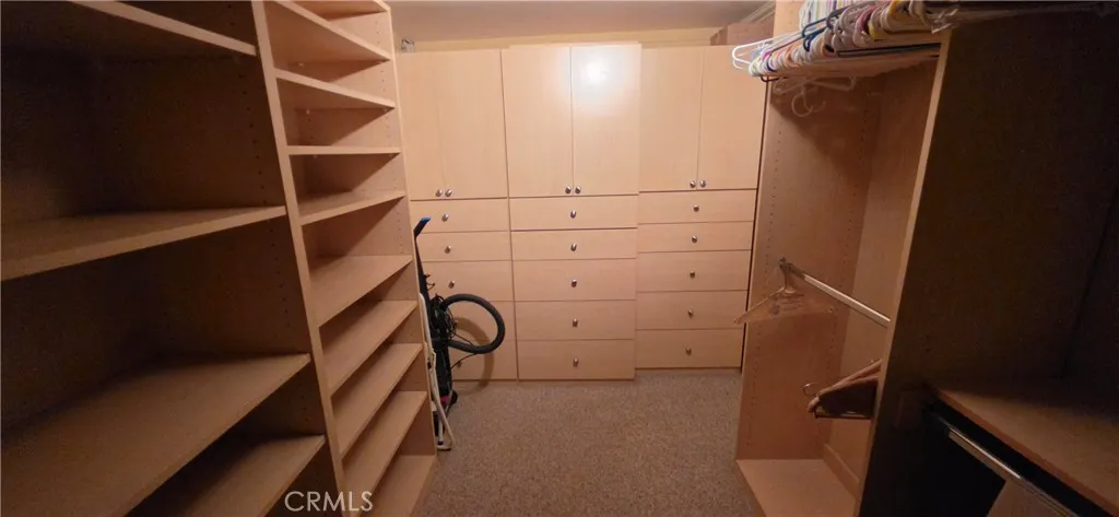 Walk-in closet with built-in shelving and storage Walk-in closet with built-in shelving and storage