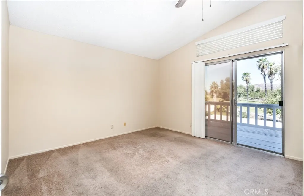 Primary bedroom upstairs with balcony overlooking the golf course. This is bedroom #2