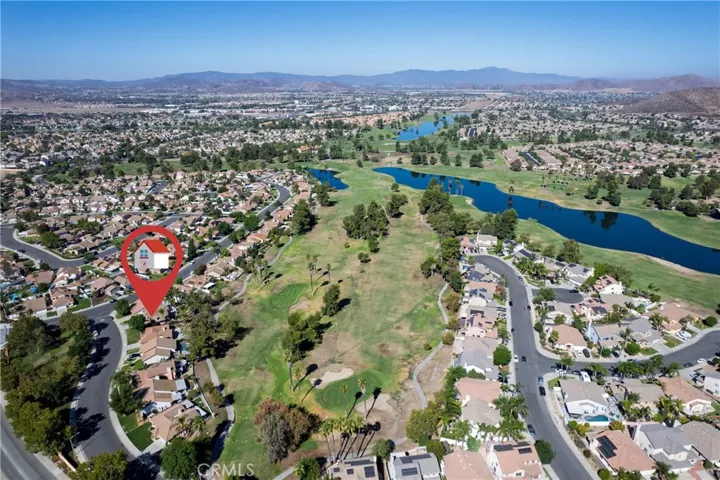 Aerial view showing the house backs up to the golf course.