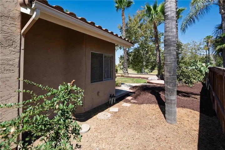 Side of the house. Golf course in the background.