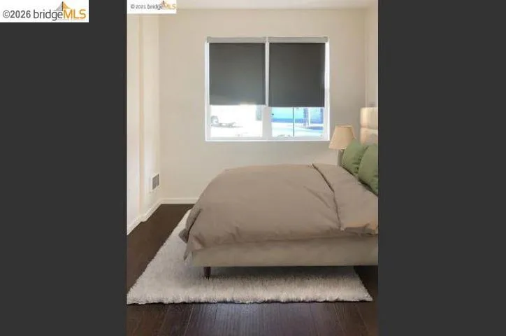 Room with a double window featuring dark roller shades