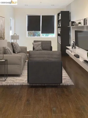 Living area featuring wood-finish flooring, recessed lighting, and a window with roller shades