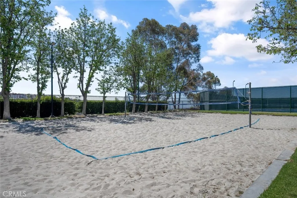 Sand volleyball between the pool area and tennis court