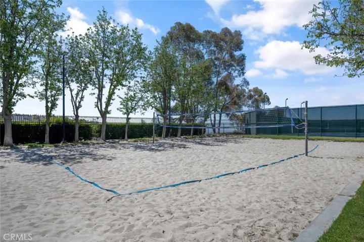 Sand volleyball between the pool area and tennis court