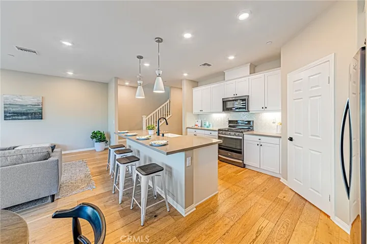 The beautifully upgraded kitchen features elegant quartz countertops and a custom handcrafted sink valued at approximately $8,000