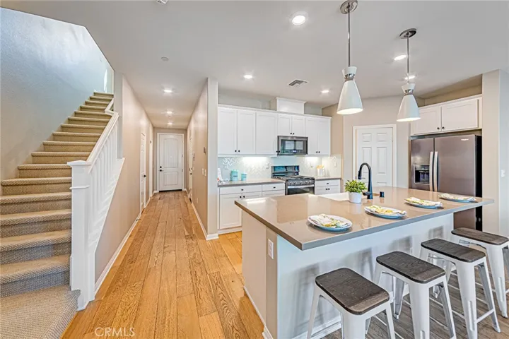 The staircase and second-floor living areas feature custom carpeting