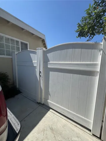 Enter through the shared driveway and white vinyl gate to your private rear ADU, tucked away behind the main home for added privacy and tranquility.