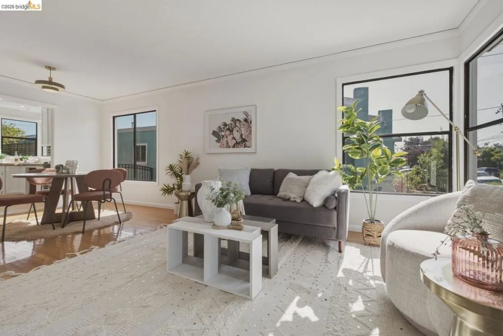 Bright open-concept living area with wood-finish flooring