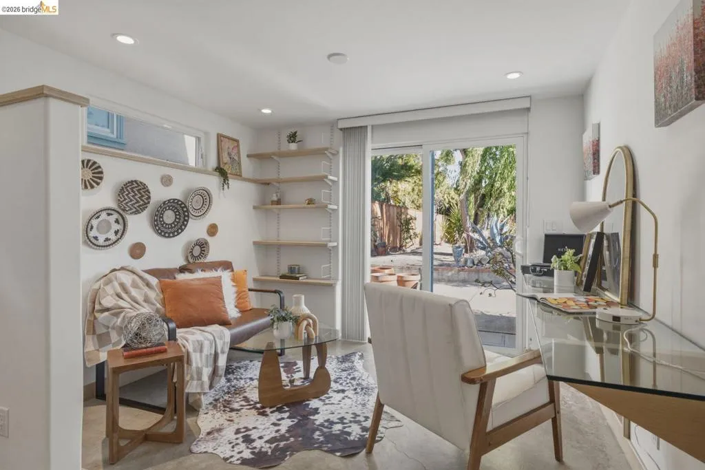 Living area featuring recessed lighting, high-set window, and a sliding glass door providing access to the exterior