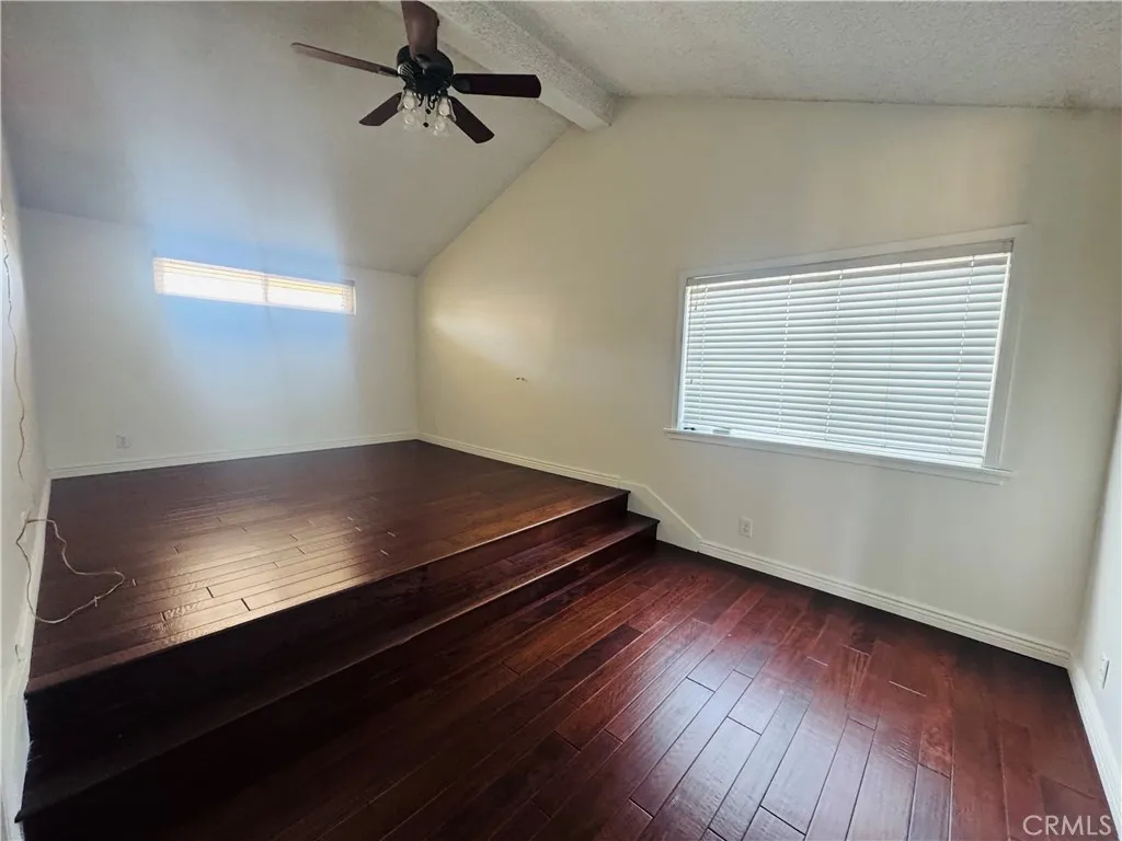 An unique secondary bedroom with vaulted ceilings and an elevated loft-style sleeping area accessed by built-in steps. An unique secondary bedroom with vaulted ceilings and an elevated loft-style sleeping area accessed by built-in steps.