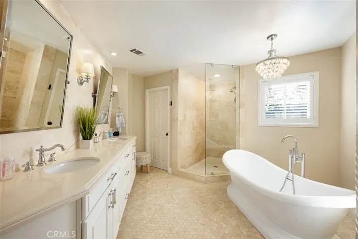The beautifully updated primary bathroom has a stall shower and freestanding bathtub.