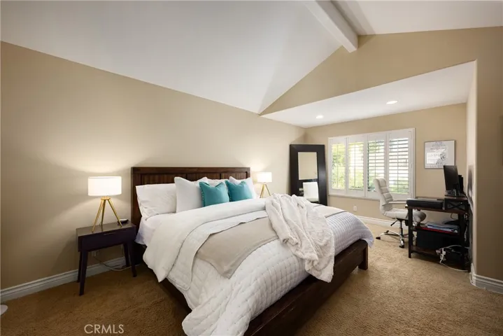 The stunning primary suite is located upstairs and features a walk in closet and vaulted ceiling.