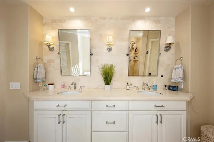 Dual vanity with Ceasarstone counters in the primary bathroom.