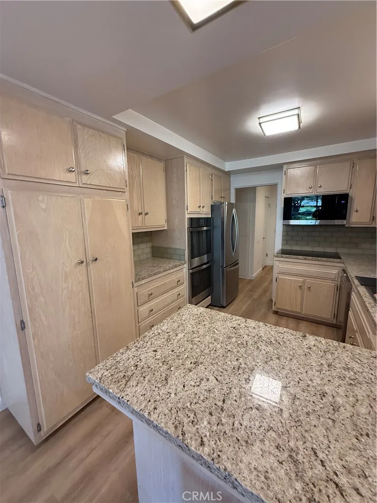 kitchen with new stainless appliances and granite counters
