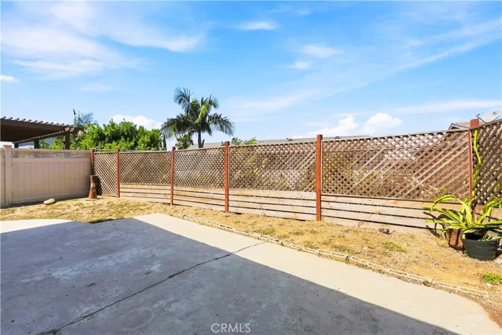 Backyard with privacy lattice fence, can install faux or real ivy for more privacy.