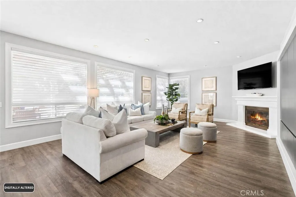 Large family room with a long wall of storage cabinets and wine storage
