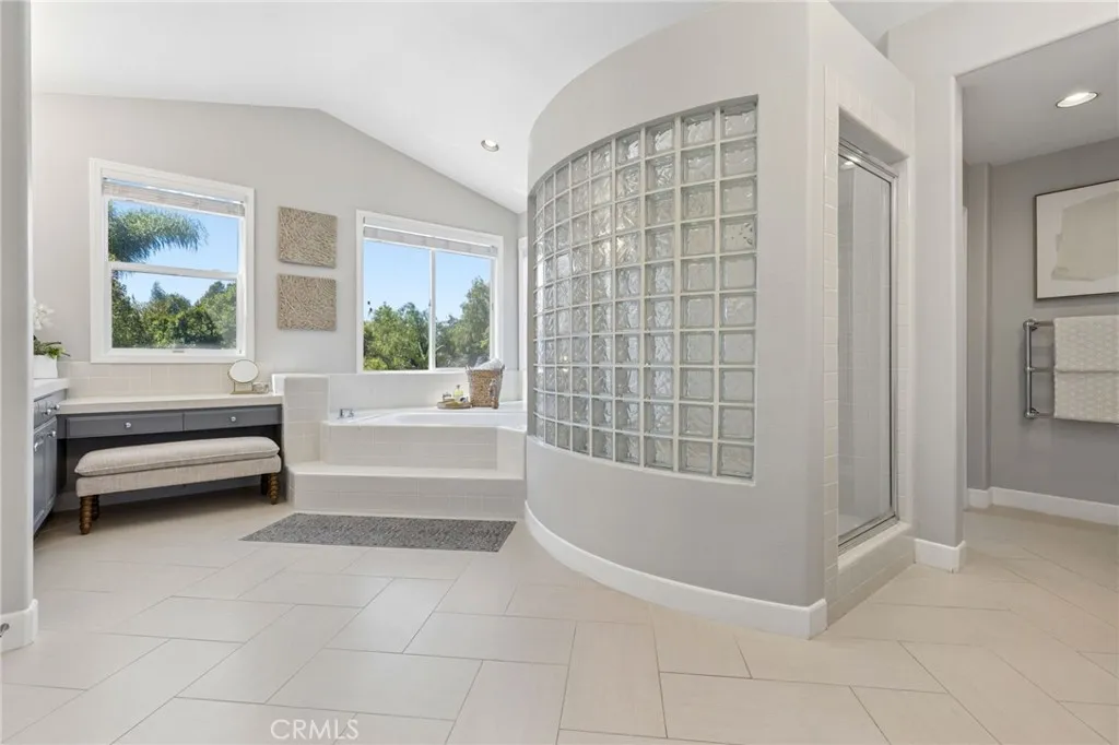 Beautiful large bathroom with separate jetted tub, glass walled shower, separate toilet room with bidet, 2nd laundry closet and large walk in closet