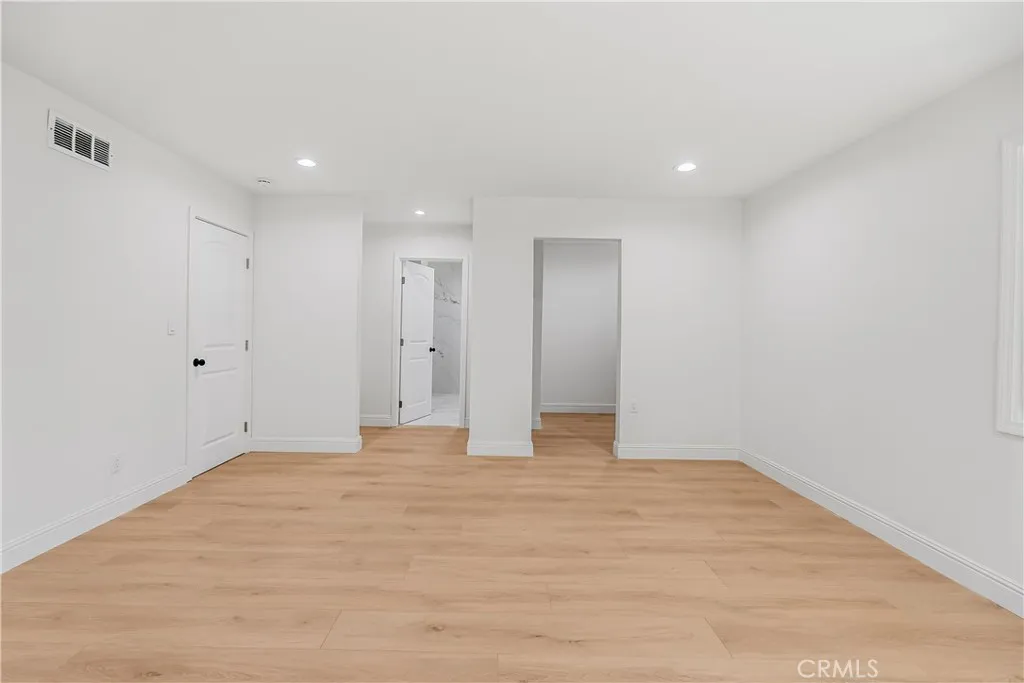 PRIMARY BEDROOM WITH A WALK IN CLOSET AND REMODELED BATHROOM