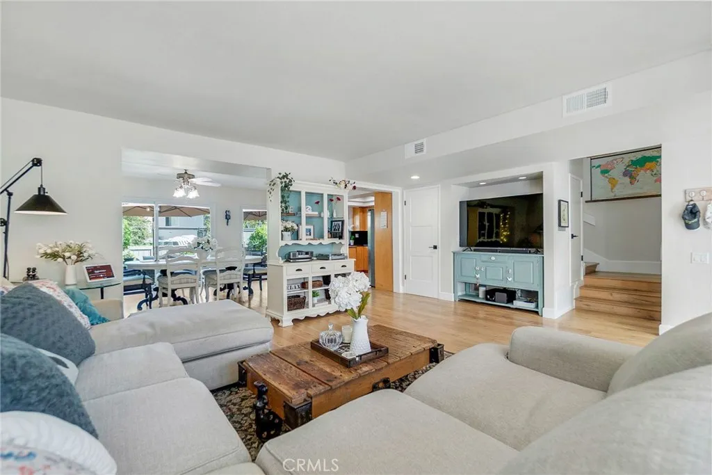 Living room towards dining room, kitchen and stairs to second story of home. Living room towards dining room, kitchen and stairs to second story of home.