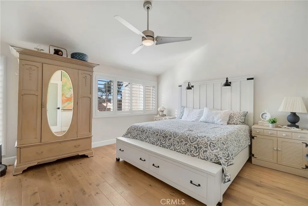 Primary bedroom including vaulted ceiling, ceiling fan with light and plantation shutters. Primary bedroom including vaulted ceiling, ceiling fan with light and plantation shutters.