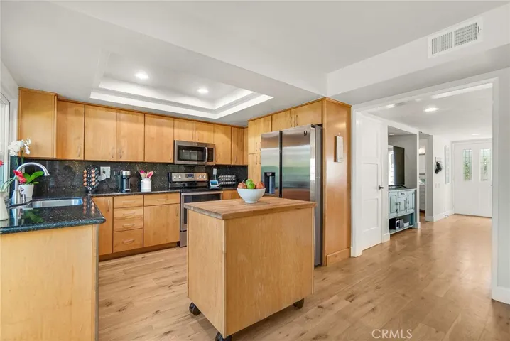 Another view of kitchen into main entry and living room.